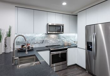 Granite and quartz countertops with full-height backsplash